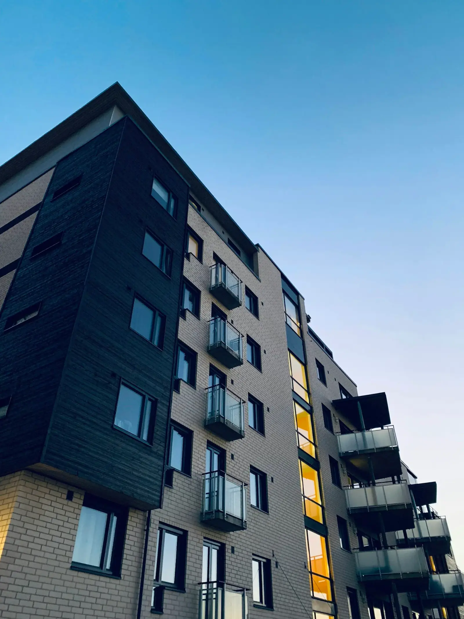 Low-angle view of a modern multi-story apartment building